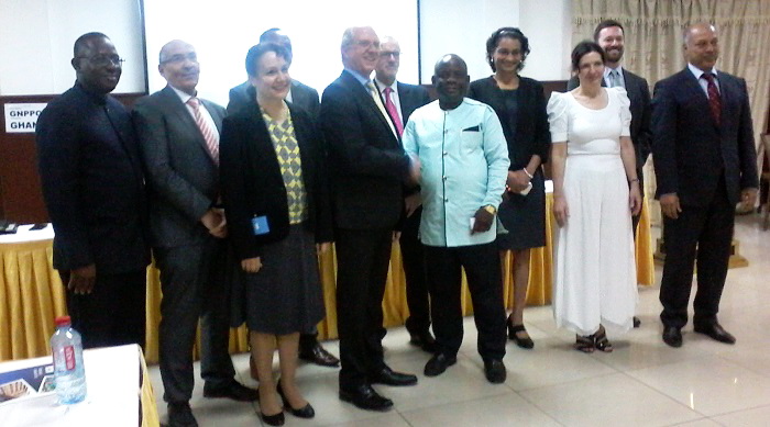 Professor Benjamin J.A. Nyarko, in a handshake with Mr Anthony Kenneth Stott. Those with them are some of the scientists.